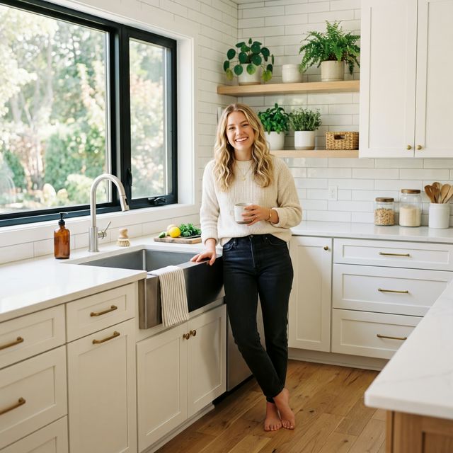 Smiling woman at a beautiful clean modern kitchen sink